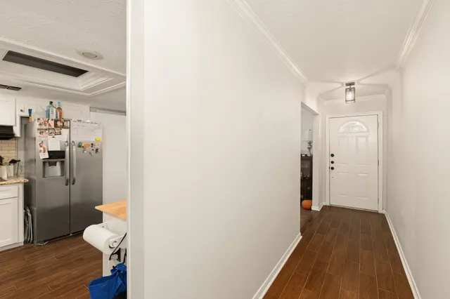a view of hallway with wooden floor