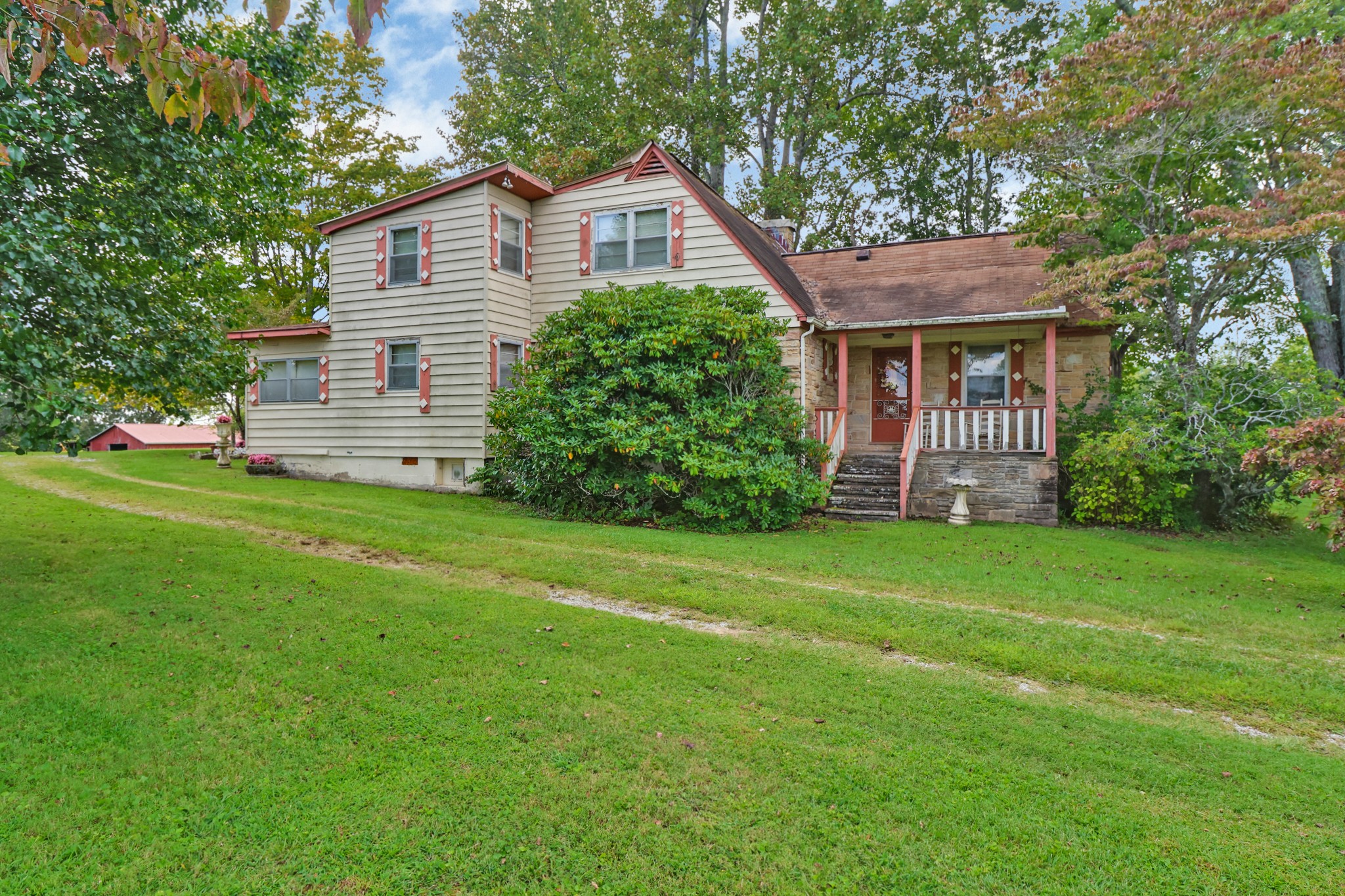 a front view of a house with a yard and trees