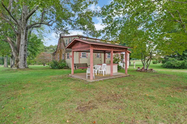 a view of a house with backyard porch and sitting area