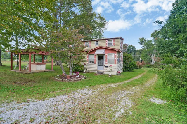 a front view of a house with a garden