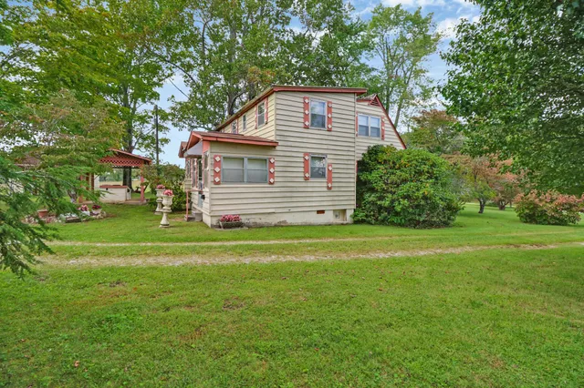 a front view of a house with a garden
