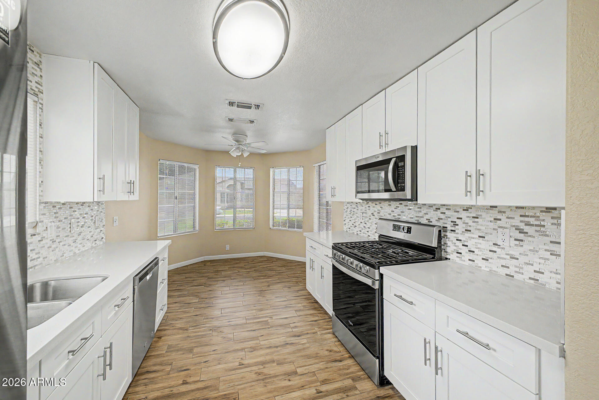 8564 West Ocotillo Road Glendale, AZ 85305 - Photo 12 of 34 a large kitchen with cabinets stove top oven and sink