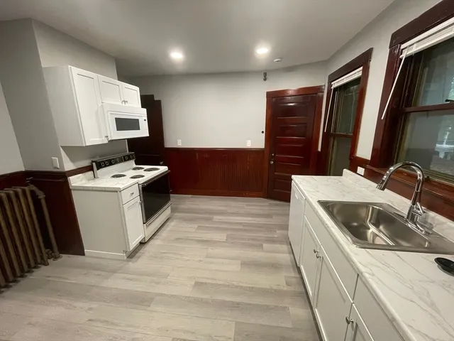 a kitchen with a sink stove and refrigerator