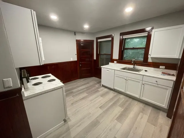 a kitchen with a stove a sink and a refrigerator