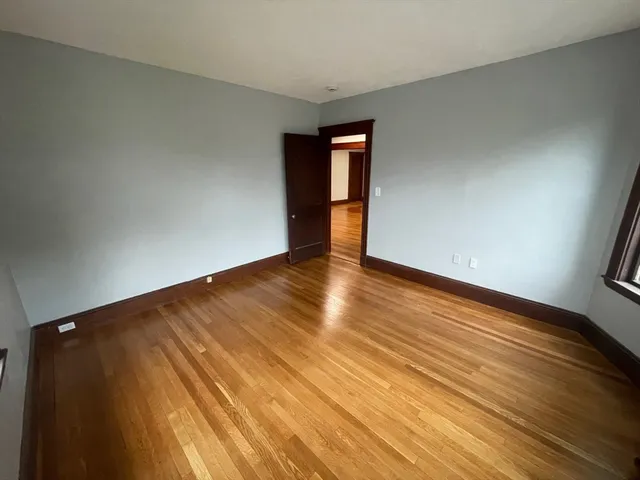 a view of an empty room and wooden floor