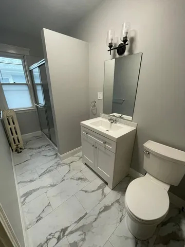 a bathroom with a sink toilet and mirror