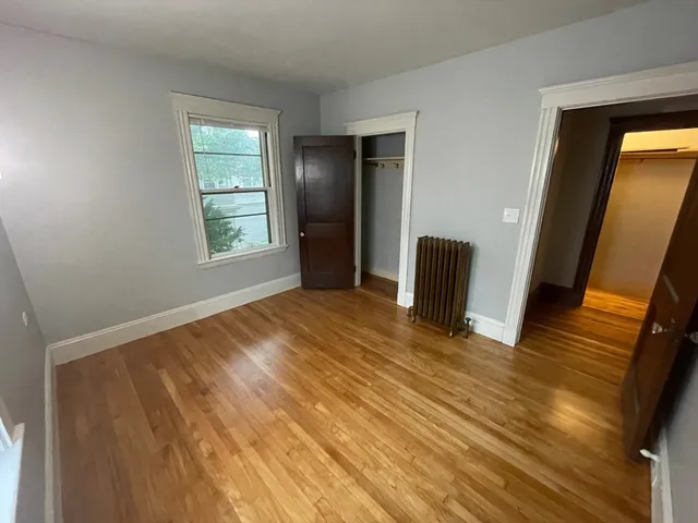a view of an empty room and wooden floor
