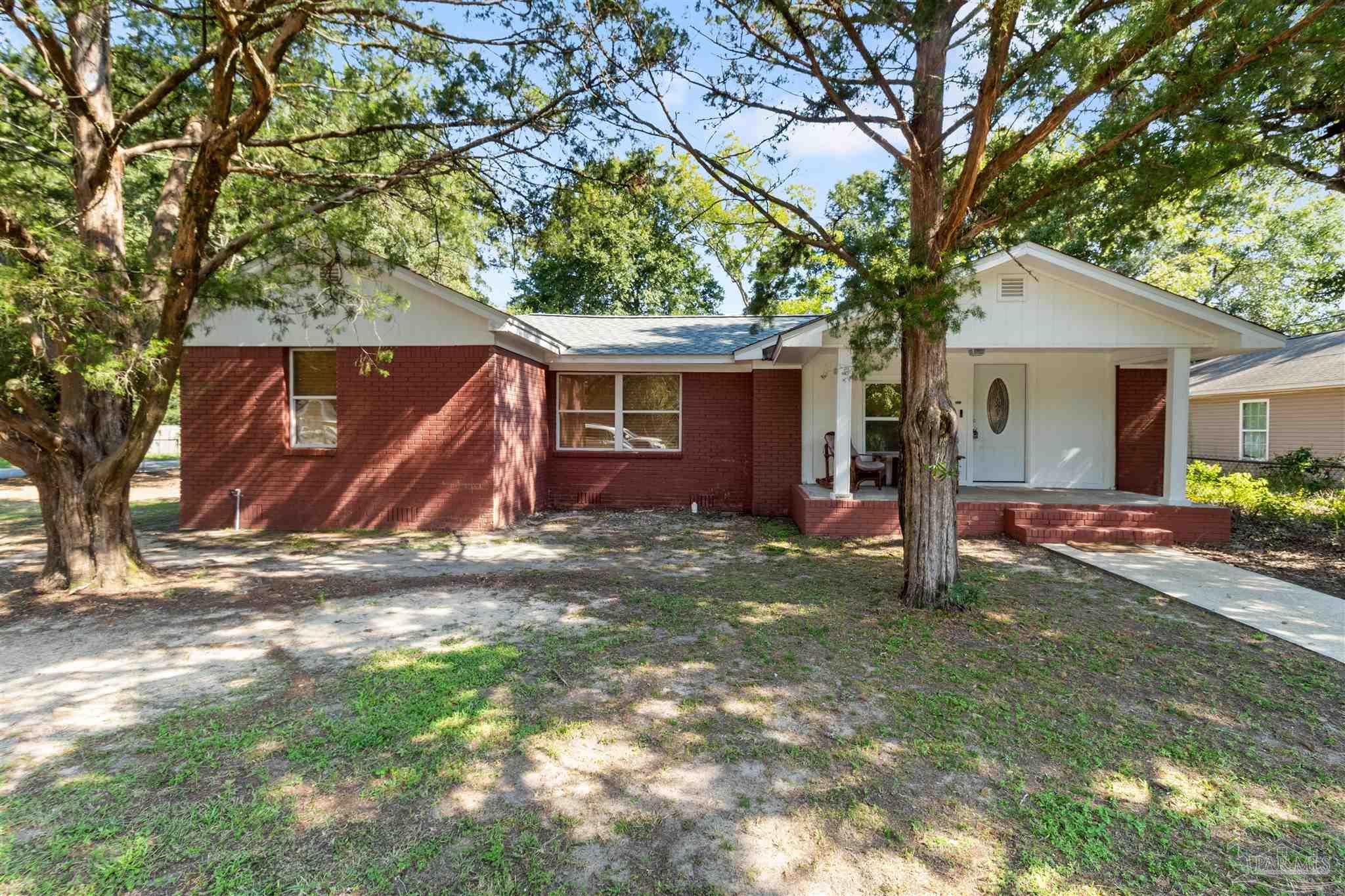 a view of a house with a tree in the yard