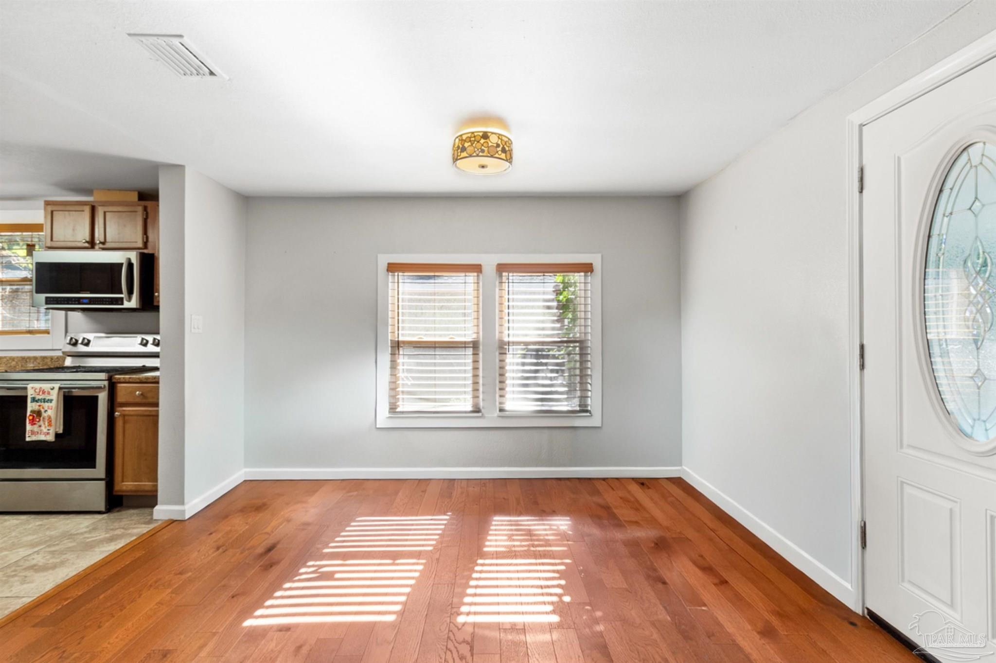 6608 Magnolia Street Milton, FL 32570 - Photo 11 of 36 a view of an empty room with a window and kitchen view