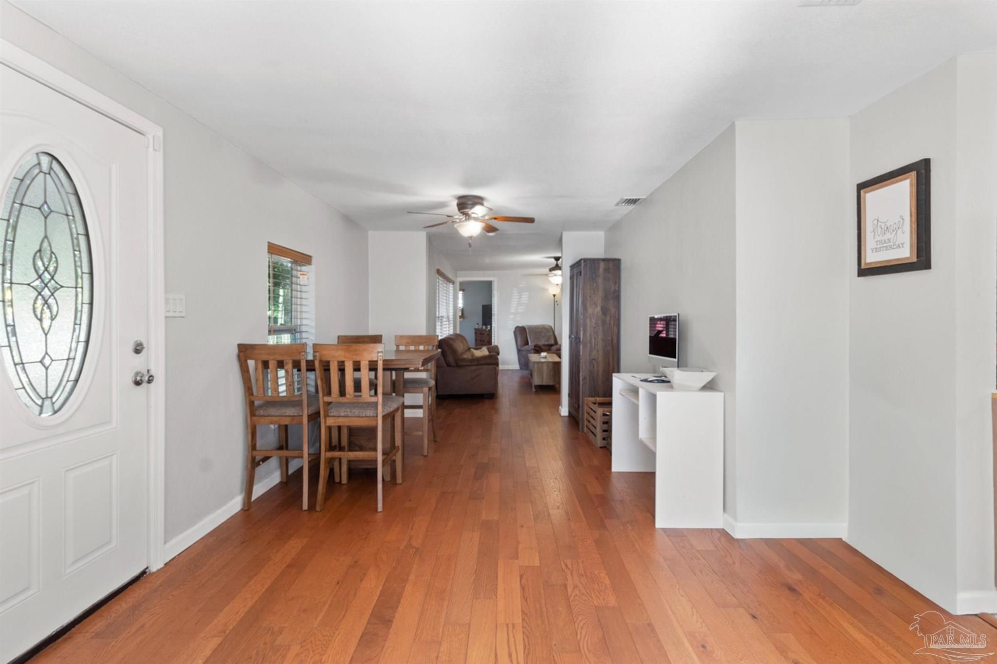 6608 Magnolia Street Milton, FL 32570 - Photo 12 of 36 a dining room with furniture and wooden floor