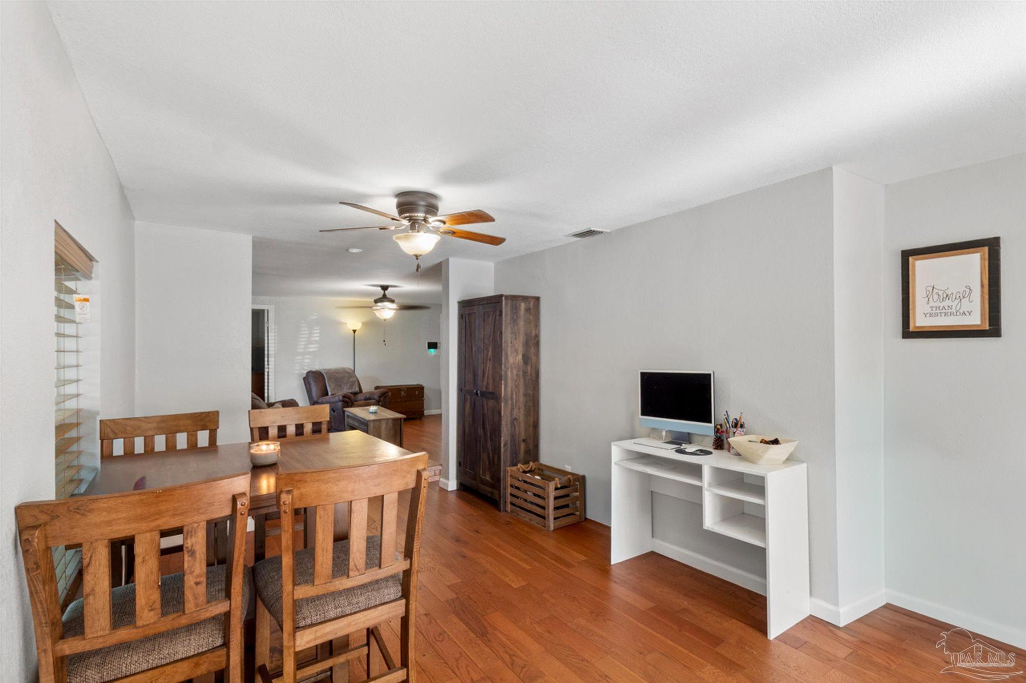 6608 Magnolia Street Milton, FL 32570 - Photo 13 of 36 a view of a workspace with furniture and wooden floor