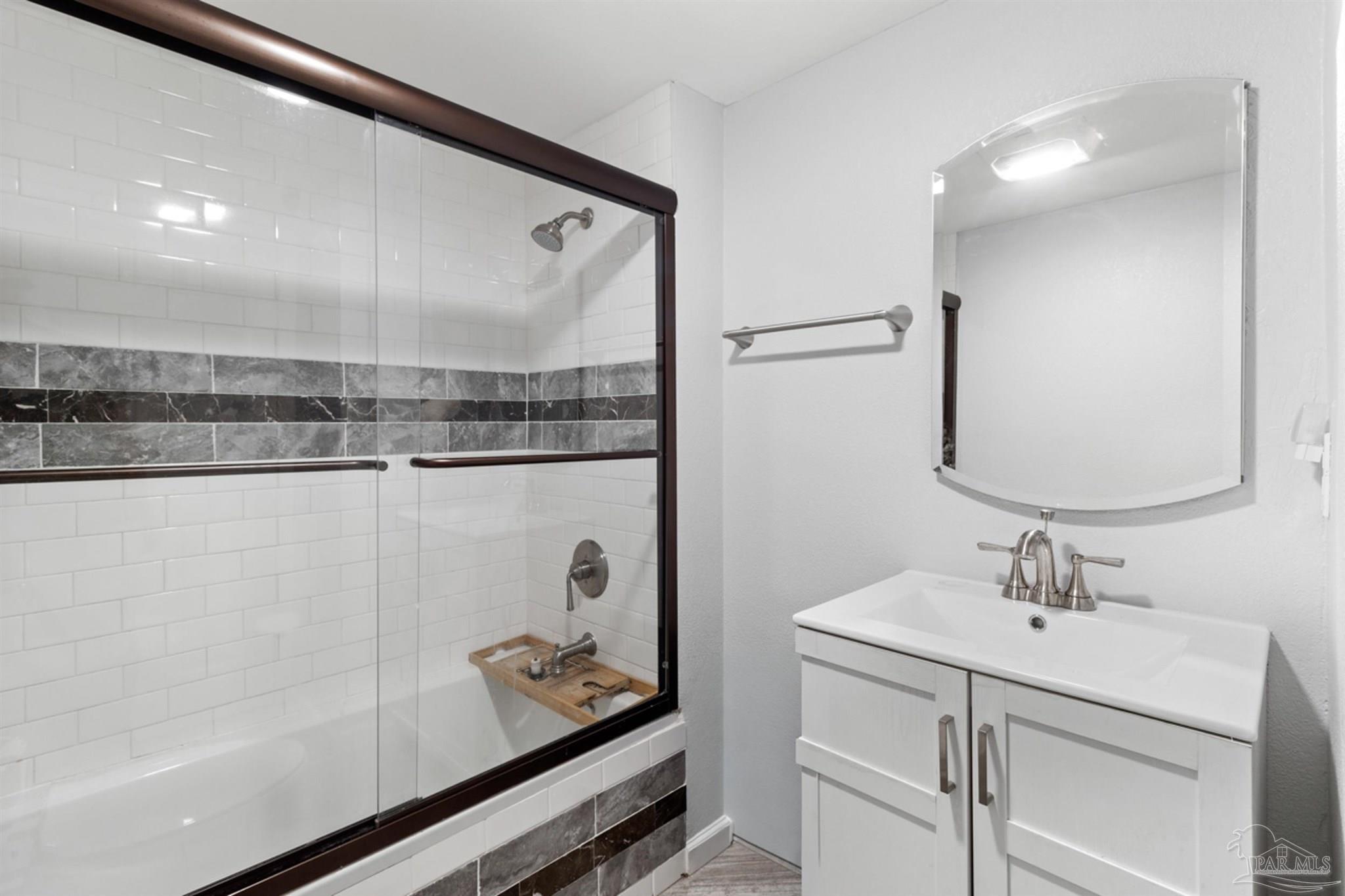 6608 Magnolia Street Milton, FL 32570 - Photo 20 of 36 a bathroom with a sink mirror and vanity
