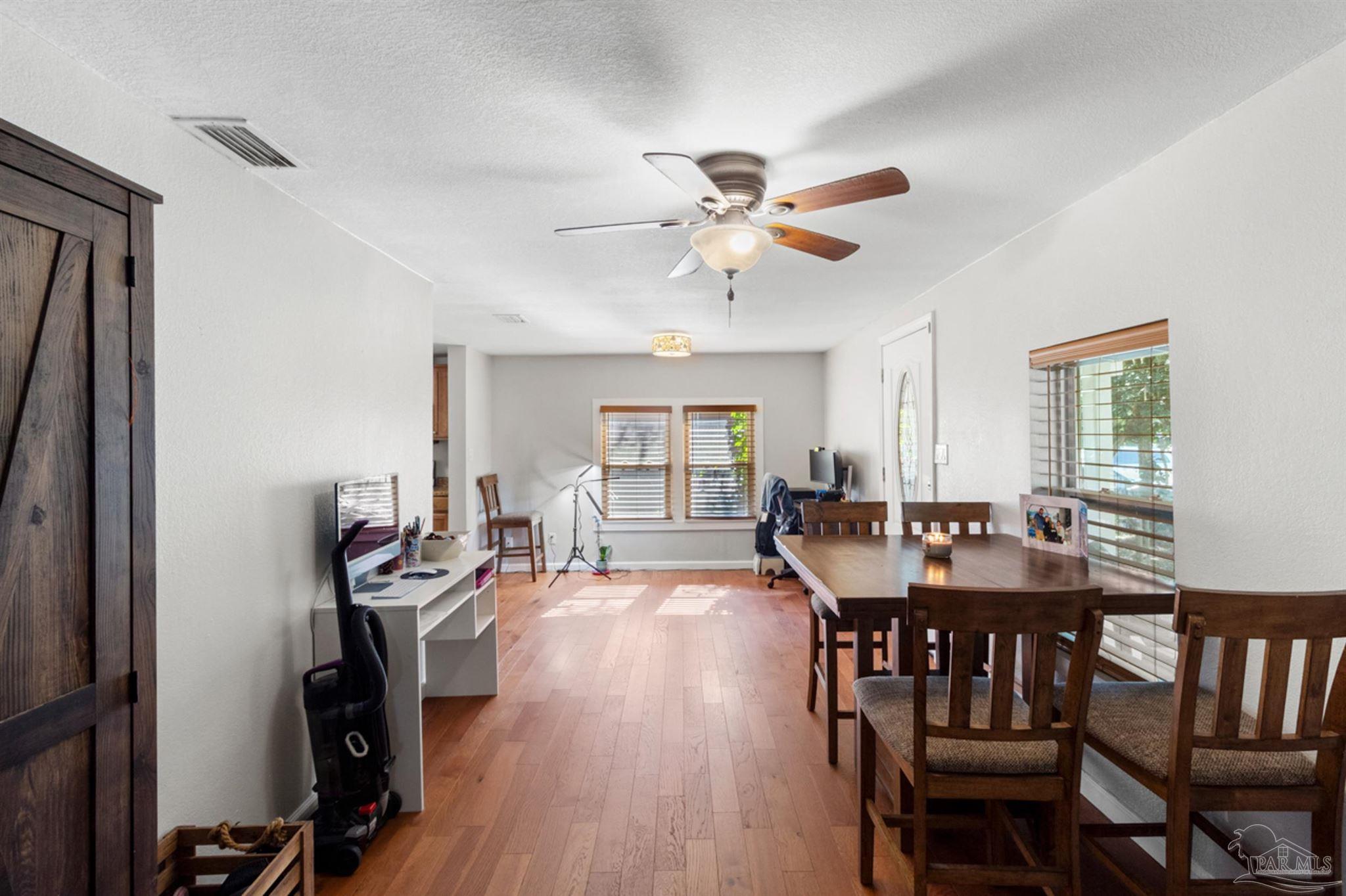 6608 Magnolia Street Milton, FL 32570 - Photo 25 of 36 a view of a dining room with furniture window and wooden floor