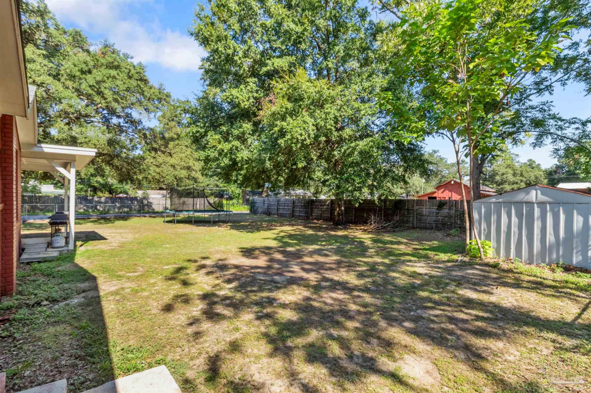 6608 Magnolia Street Milton, FL 32570 - Photo 26 of 36 a view of a swimming pool with a patio