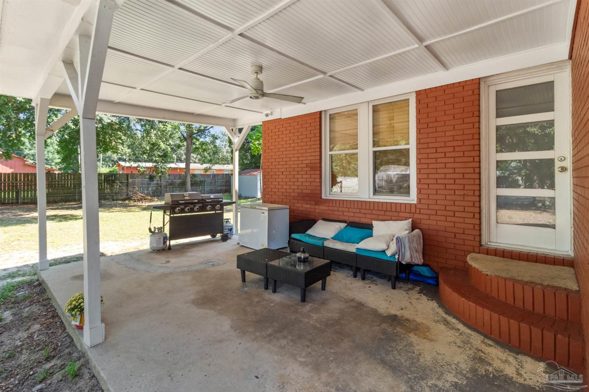 6608 Magnolia Street Milton, FL 32570 - Photo 32 of 36 a backyard of a house with outdoor seating