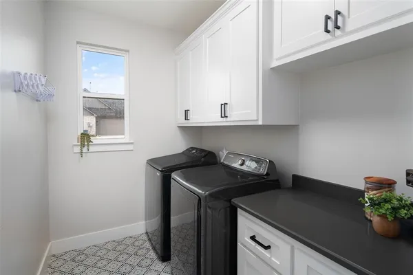 a utility room with sink dryer and washer