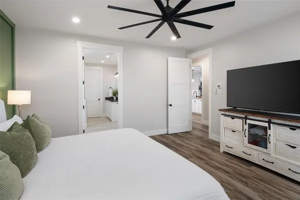 a bedroom with a bed and a flat screen tv