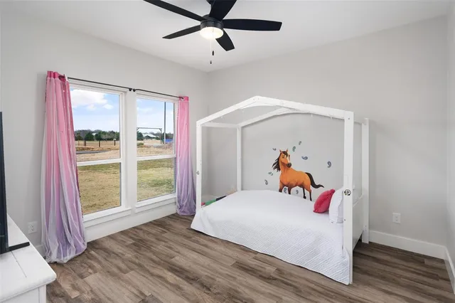 a bedroom with a bed and a large window