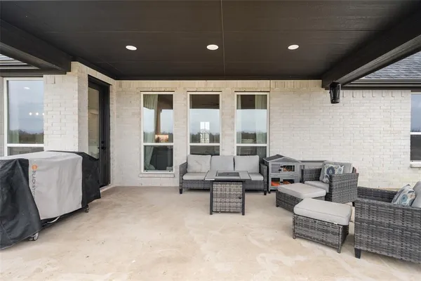 a living room with furniture and large windows