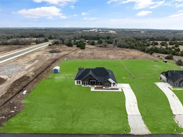 a view of a backyard with sitting area