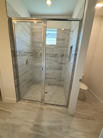 a bathroom with a glass door shower