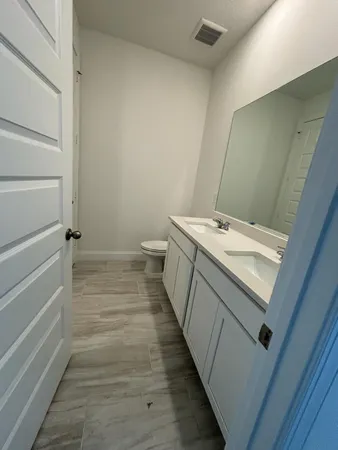 a bathroom with a sink a toilet and vanity