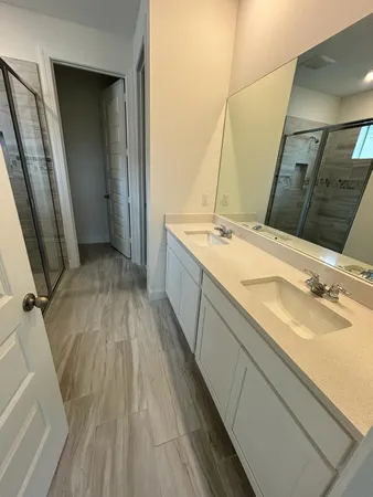 a bathroom with a granite countertop sink toilet and shower