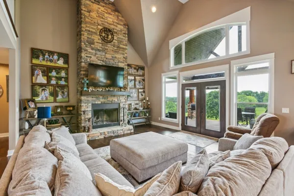 a living room with furniture large window and a fireplace