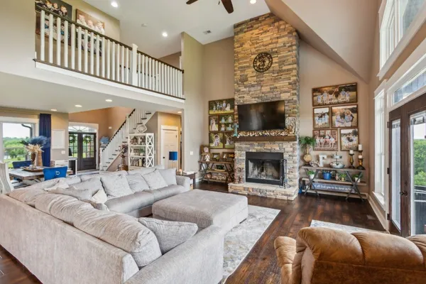 a living room with furniture a fireplace and a flat screen tv