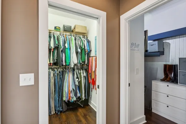 a view of walk in closet with clothes and shoes