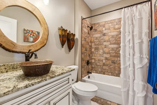 a bathroom with a toilet sink and shower