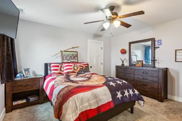 a bedroom with a bed and a dresser in it