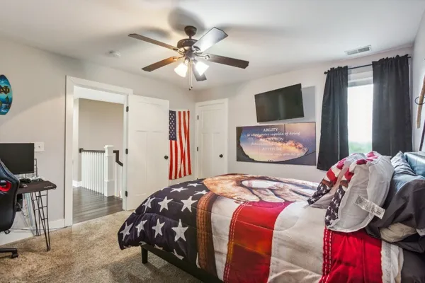 a bedroom with a bed and a flat screen tv