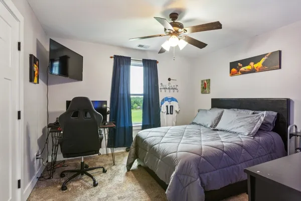 a bedroom with a bed and a desk