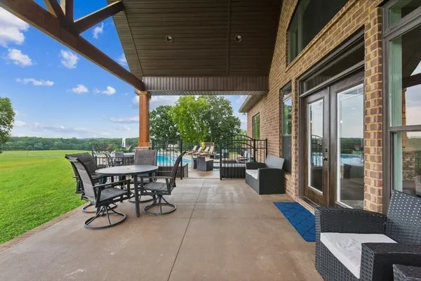 a view of a patio with table and chairs and potted plants