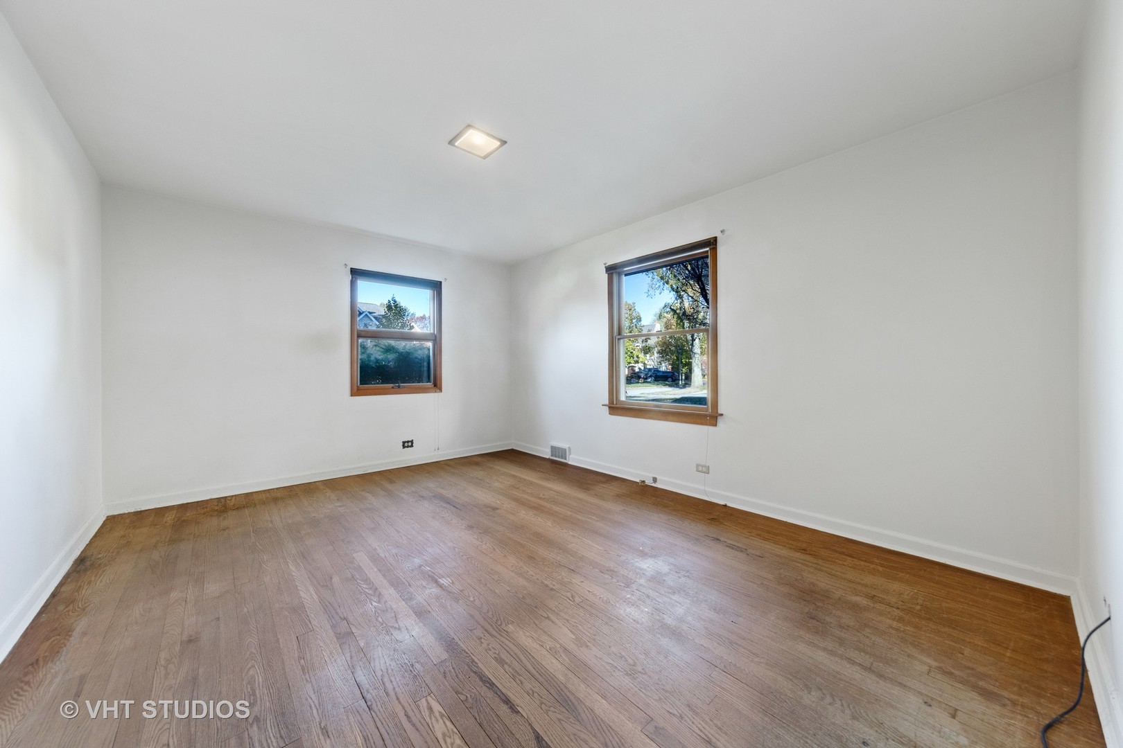 457 Utley Road Elmhurst, IL 60126 - Photo 12 of 23 an empty room with wooden floor and window