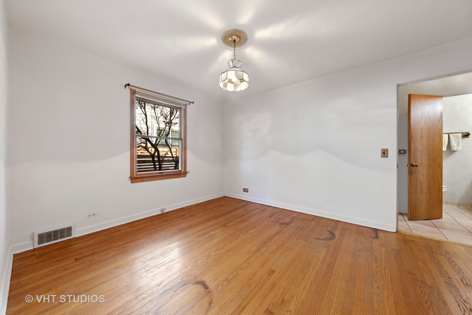 457 Utley Road Elmhurst, IL 60126 - Photo 14 of 23 wooden floor in an empty room with a window