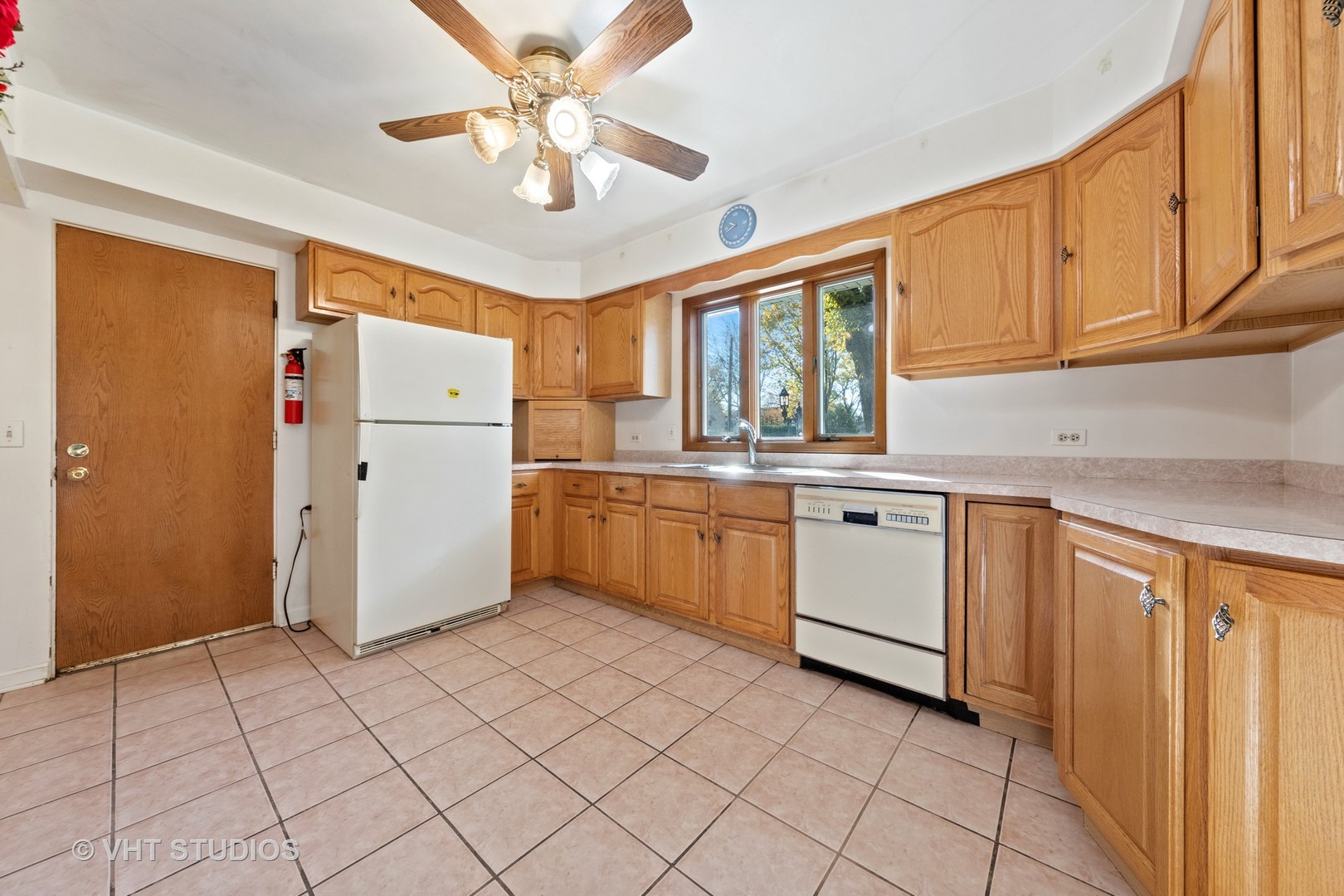 457 Utley Road Elmhurst, IL 60126 - Photo 9 of 23 a kitchen with a refrigerator a sink dishwasher and cabinets with wooden floor