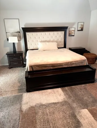 a bedroom with a bed and a couch