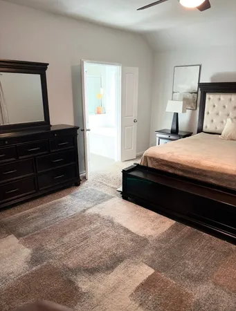 a bedroom with a bed and a dresser