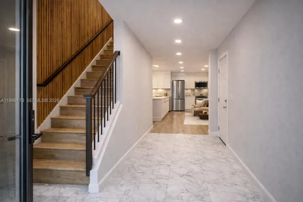 a view of entryway and hall with wooden floor