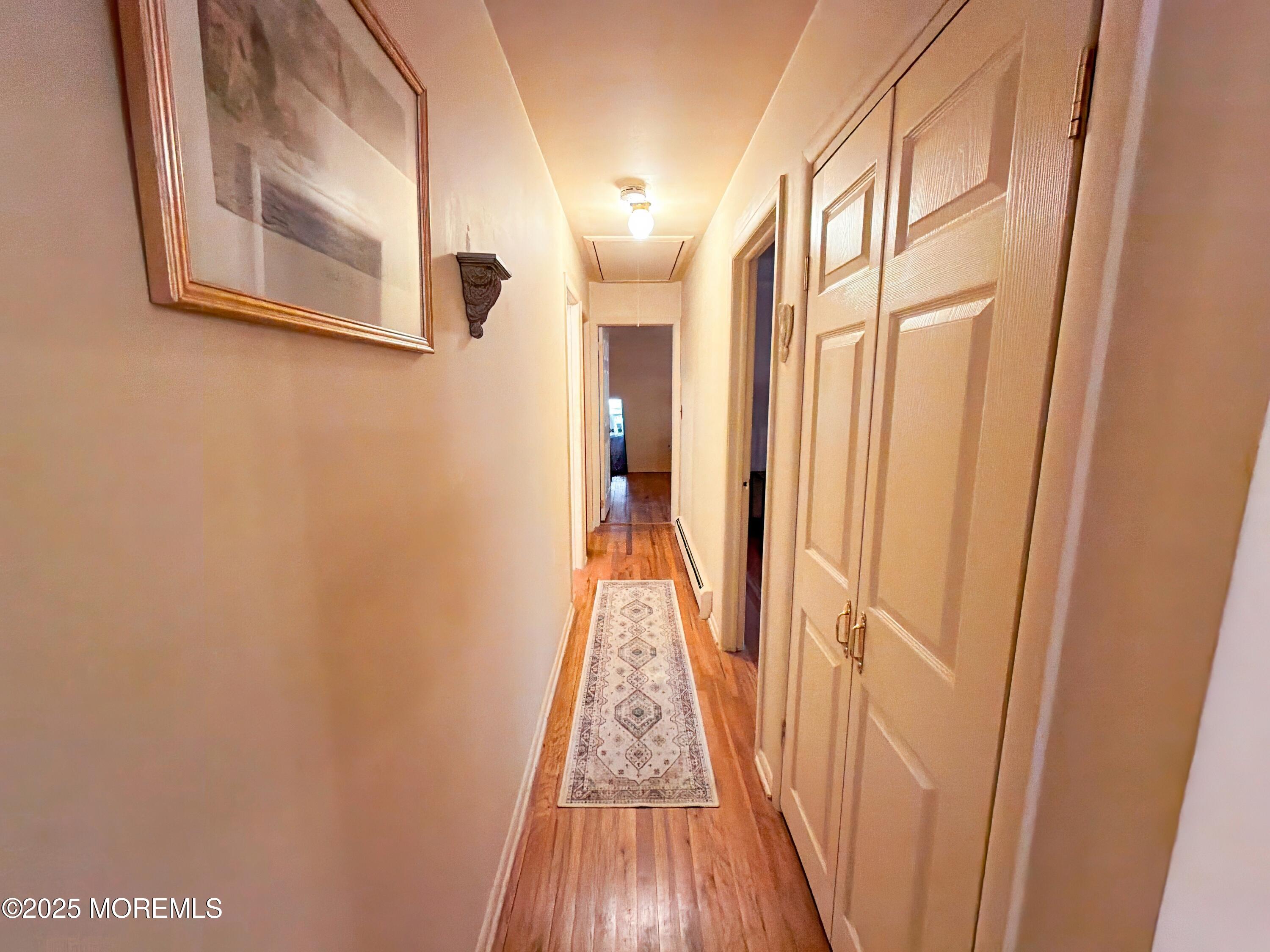 2 Corey Lane, Unit C Jackson, NJ 08527 - Photo 14 of 32 a view of a hallway with wooden floor and a bathroom