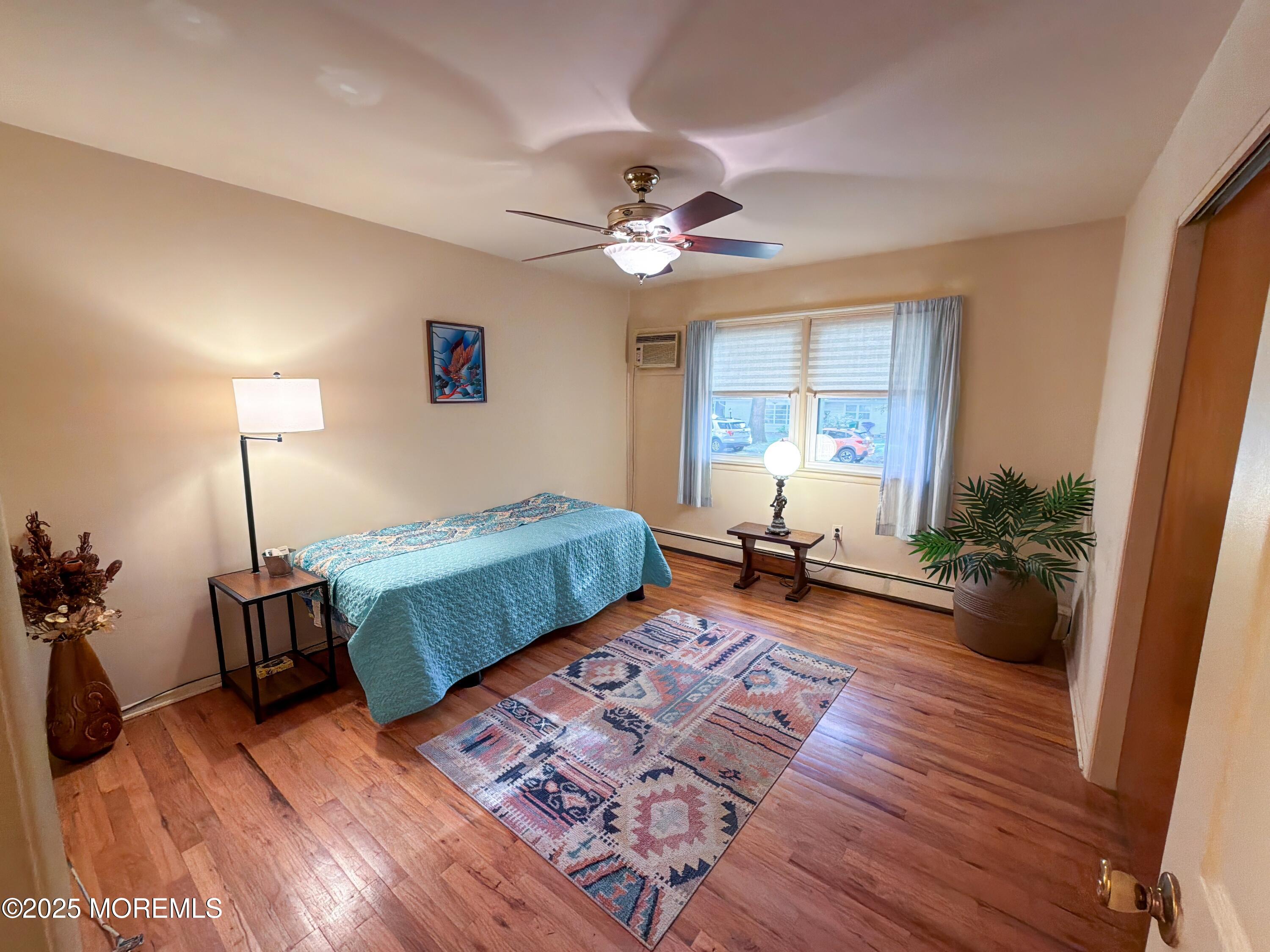 2 Corey Lane, Unit C Jackson, NJ 08527 - Photo 17 of 32 a bedroom with furniture and a wooden floor