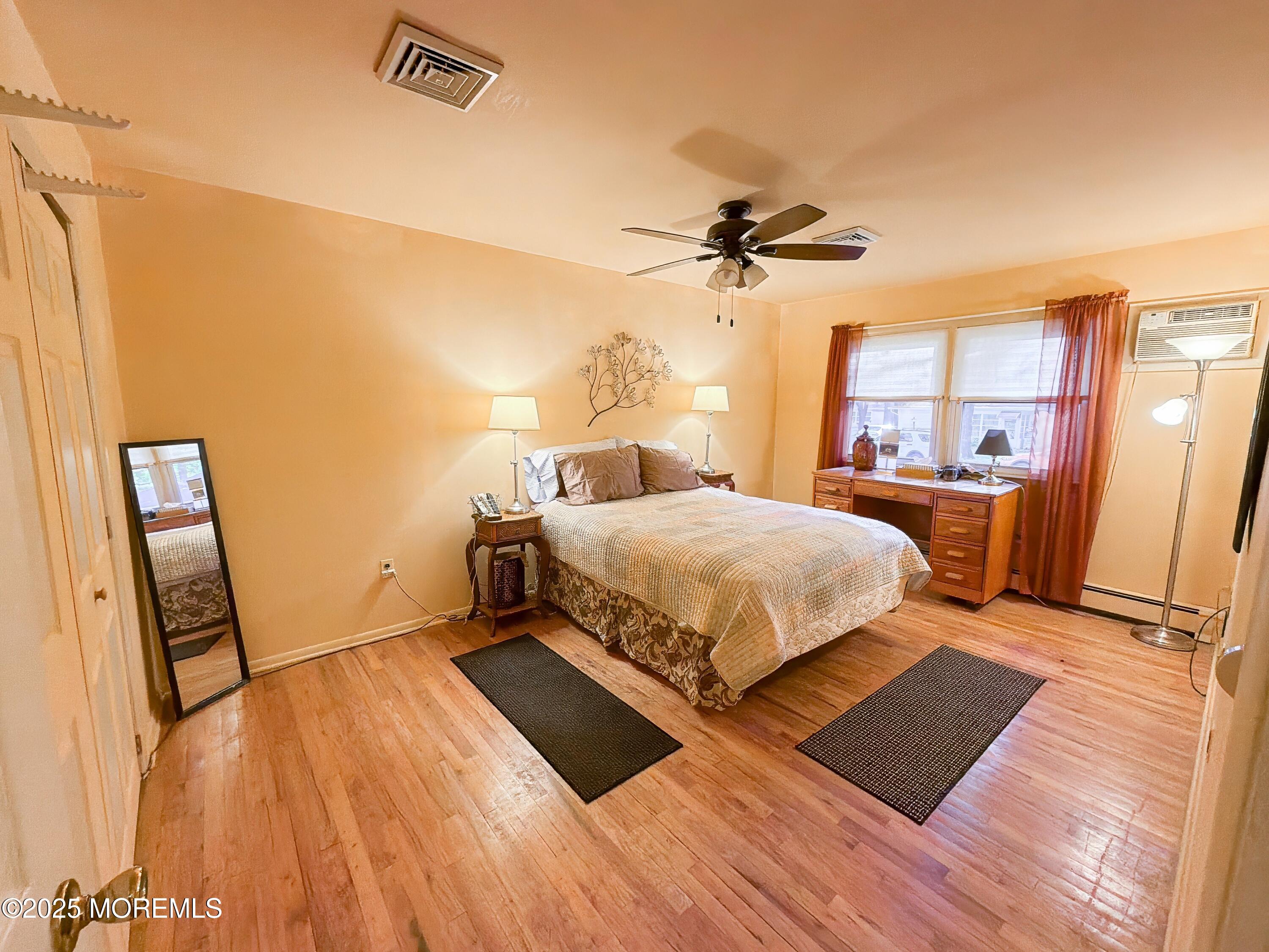 2 Corey Lane, Unit C Jackson, NJ 08527 - Photo 19 of 32 a bedroom with a bed and wooden floor