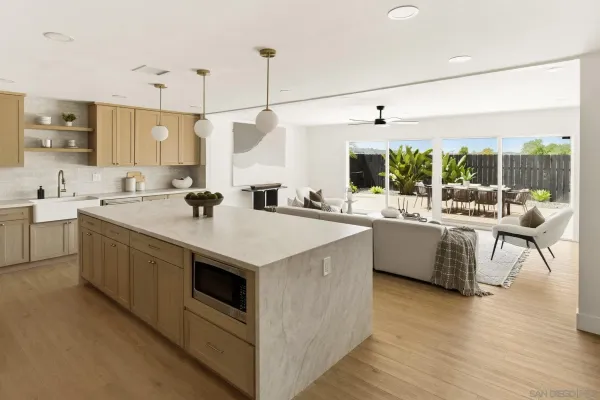 a kitchen with a stove a sink and wooden floor