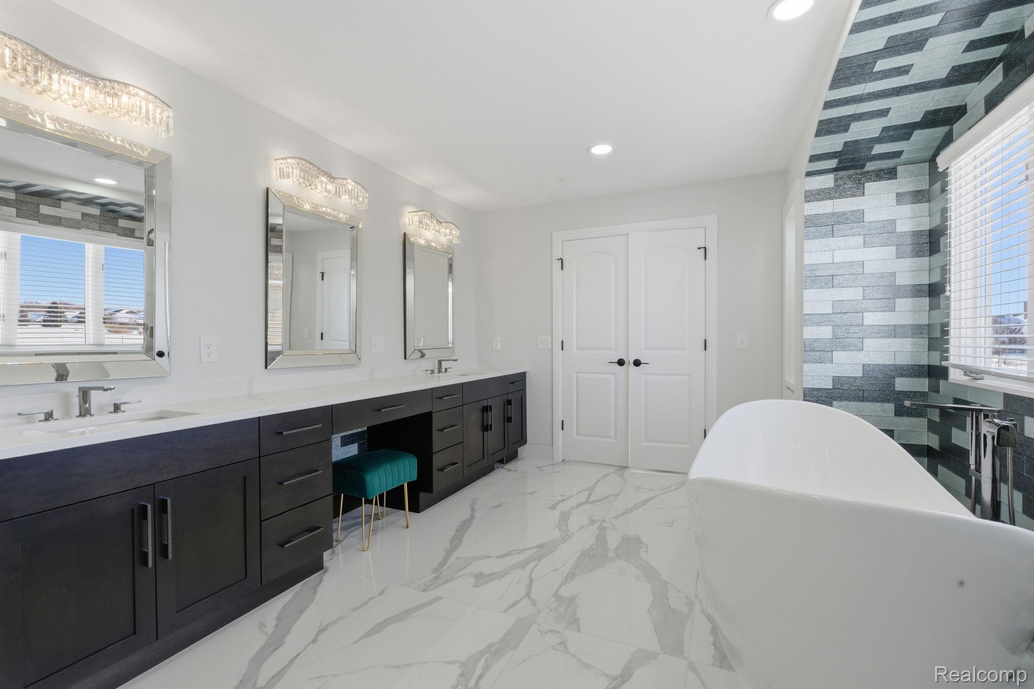 8844 Ridge Drive Washington, MI 48095 - Photo 33 of 51 Full bath with plenty of natural light, double vanity, a soaking tub, recessed lighting, and light marble finish flooring