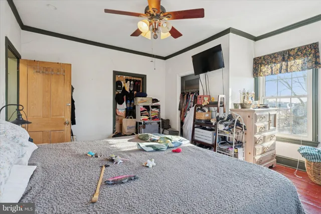 a view of a livingroom with workspace and a window