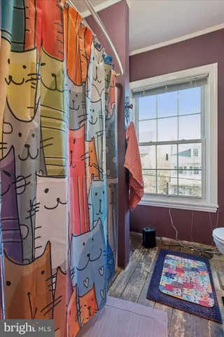 a living room with furniture chess table and a flat screen tv