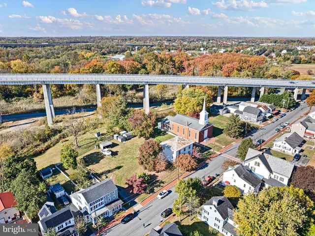 a view of road with large trees
