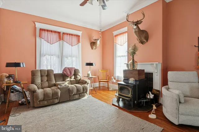 a living room with furniture a flat screen tv and a window